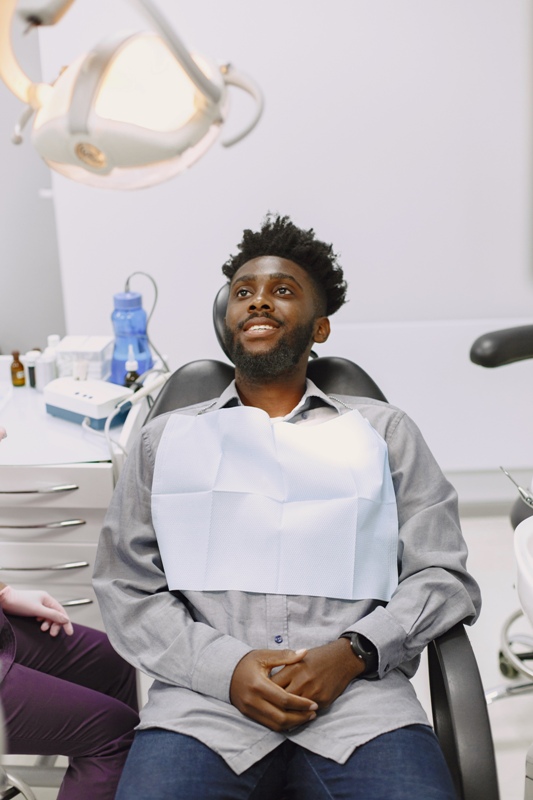 African patient in dentistry sitting in dental chair